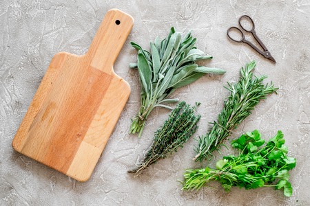 making spices with fresh herbs and greenery for cooking stone kitchen table background top view mockupの写真素材