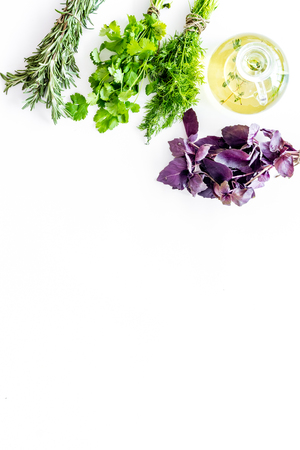 home cooking with fresh greenery and organic oil on white kitchen table background top view mock upの写真素材