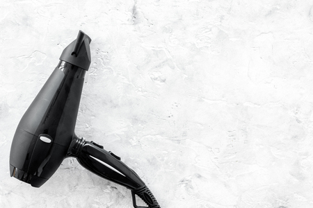 hairdresser tools with drier for styling on gray stone work desk background top view mockupの写真素材