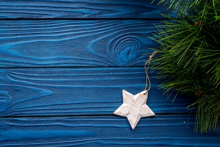 New Year decorations with christmas tree branche and star on blue wooden table background top veiw mock upの写真素材