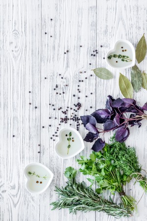 greenery with natural oil for cooking on light wooden kitchen table background top view mock-upの写真素材