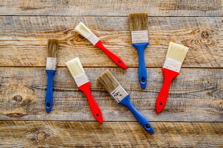 building, painting and repair tools for house constructor work place set on wooden background top viewの写真素材
