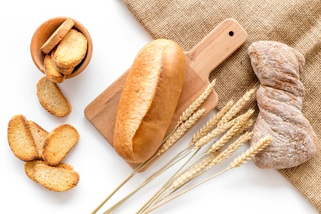 bakery shop set with fresh wheaten bread on table white background top view