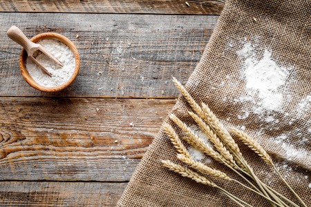 wheat and rye ear for flour production in bakery on wooden desk background top view mockupの写真素材