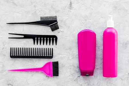 pink combs, brushes and spray for hairdresser work set on stone desk background top viewの写真素材