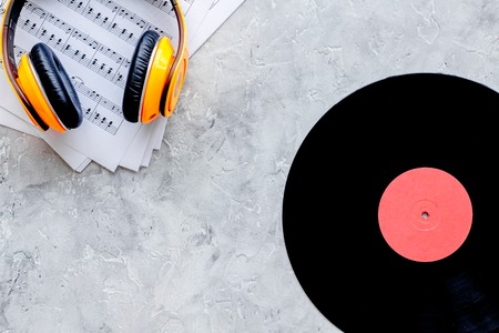 songwriter or dj work place with vynil and headphones on stone desk background top view mockup