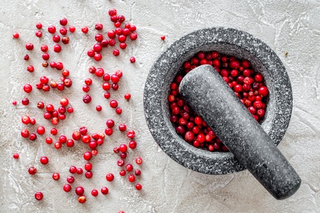 Food set with various berries for making spices and mortar on stone background top viewの写真素材