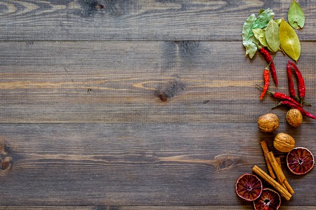 Kitchen table with spices and dry herbs on wooden kitchen background top view mock upの写真素材