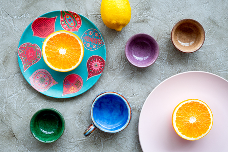 Crockery pattern. Cups and plates near tropical leaves and fruits on grey background top view.の写真素材