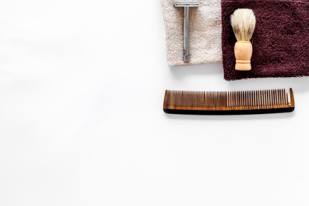 Workplace in barbershop with tools. Razor, shaving brush, comb on white background top view.