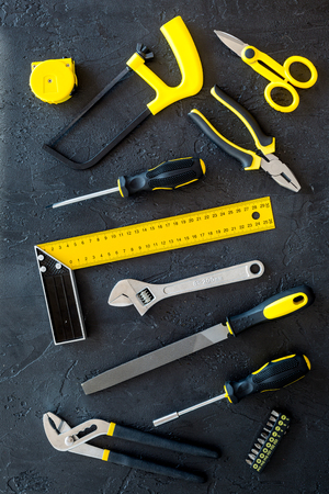 constructor desk pattern with set of building implements on dark desk background top viewの写真素材