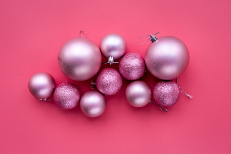 Christmas toys. Pink balls on pink background top view.の写真素材