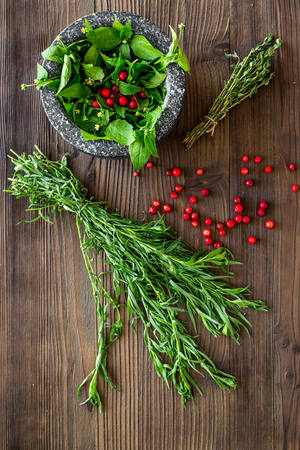 close up of ingredients for making spices and herbs in mortar on wooden background top viewの写真素材