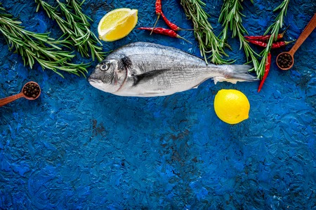 Ingredients for cooking dorado fish on blue background top view.の写真素材