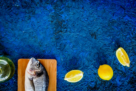 Ingredients for cooking dorado fish on blue background top view.の写真素材