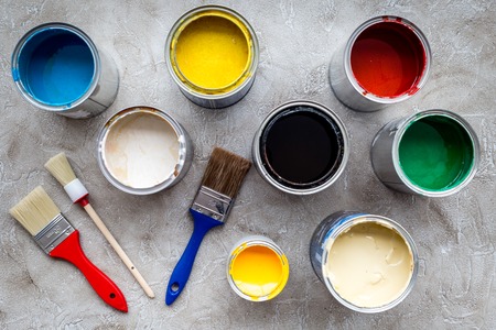 Paints in tin banks and brushes on grey stone background top view.の写真素材