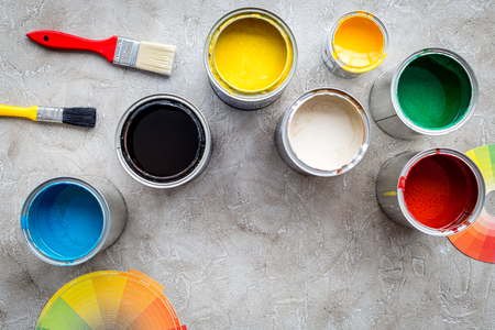 Paints in tin banks and brushes on grey stone background top view copyspaceの写真素材