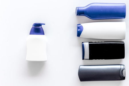 Shampoo and shower gel for men on white background top view