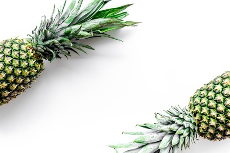 Tropical fruits background. Pinneapple on white top view copyspace