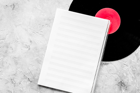Workplace of musician. Music notes, vinyl record and coffee on grey background top view.の写真素材