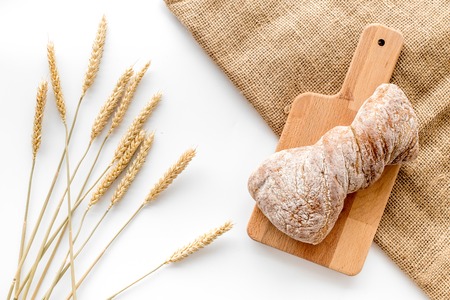 bakery shop set with fresh wheaten bread on table white background top viewの写真素材