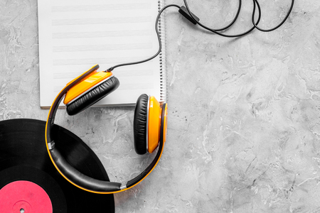 Compose music. Vinyl records, headphones, music notes on grey background top view copyspaceの写真素材