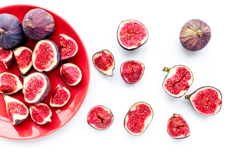 Plate of fresh blue figs on white background top viewの写真素材