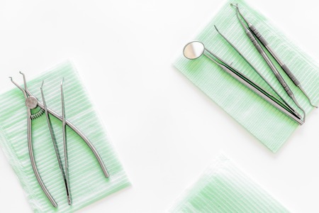 Dentists accessories. Tools on white background top view.の写真素材
