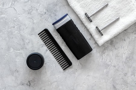 Mens shaving. Tools and cosmetics on grey stone background top view copyspaceの写真素材