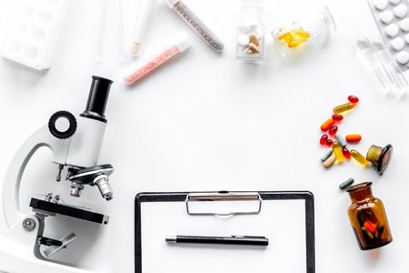 Do medcal tests. Microscope, tablet, pills and test tube on white background top view.の写真素材