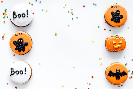 Bright halloween gingerbread cookies pattern on white background top view copyspace