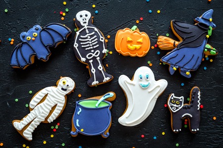 Bright halloween gingerbread cookies background on black background top viewの写真素材