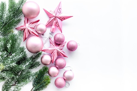 Christmas toys pattern. Pink stars near pine branches on white background top view.の写真素材