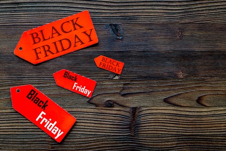 Words black friday on red labels on dark wooden background top view copyspaceの写真素材