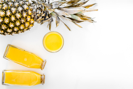 Fresh pineapple juice in glass and bottle on white background top view copyspaceの写真素材