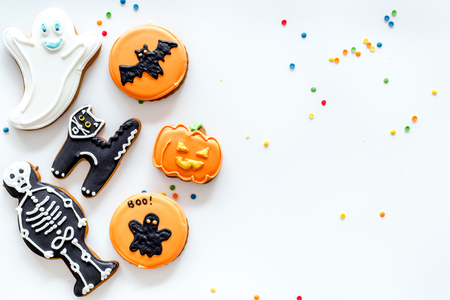 Bright halloween gingerbread cookies on white background top view.の写真素材