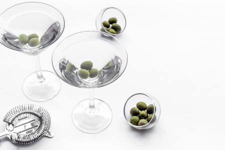 Martini cocktail in glass with olives at the bottom on white background top view.の写真素材