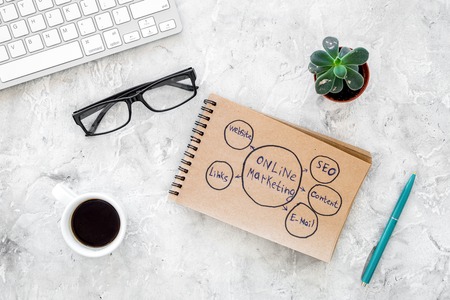 Write a business plan. Office workplace with sketch in notebook on grey background top view