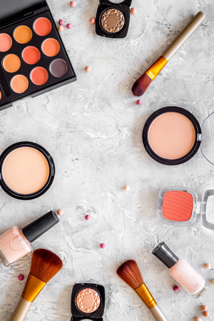 Eye shadows and rouges beige, nude colors on grey background top view.の写真素材