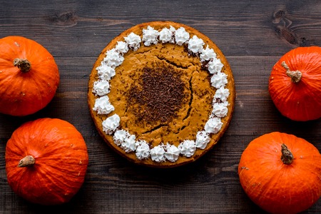 Pumpkin pie for thanksgiving day on dark wooden background top view.の写真素材