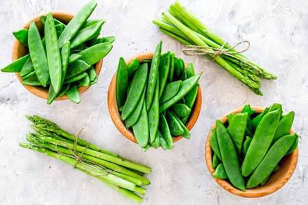 Healthy vegetarian food. Asparagus and pea on grey stone background top view.の写真素材