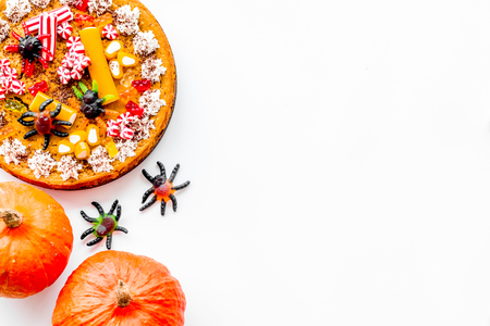 Pie for halloween with gummy spiders on white background top view.の写真素材