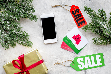 Sale for new year gift online order with card and device on stone desk background top view space for textの写真素材