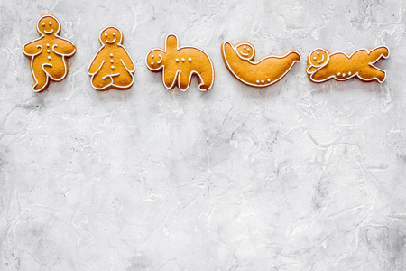 Gingerbread cookies in shape of yoga asanas on stone background top view.の写真素材
