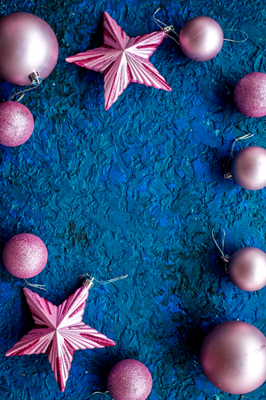 Christmas background. Toys, balls, stars on blue desk background top view mockupの写真素材