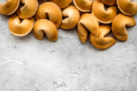 Prediction in fortune cookie on stone table background flat lay mockup
