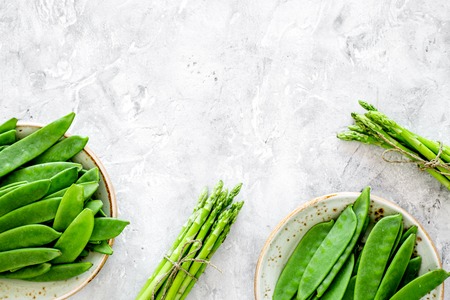 Healthy vegetarian food. Asparagus and pea on grey stone background top view.の写真素材