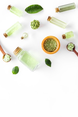 organic cosmetic set with tea olive oil and sea salt in bottle on white table background flat lay mockupの写真素材