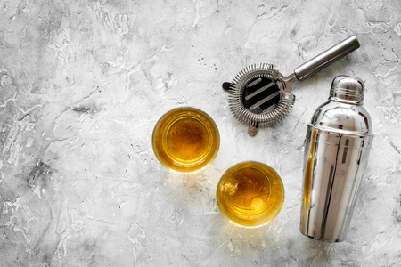 Bartender equipment for making cocktail with whiskey on the bar counter stone gray background top view mock upの写真素材