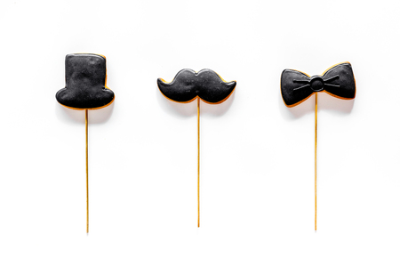 Black tie, mustache and hat cookies on sticks for happy father's day present cookies on white background top viewの写真素材